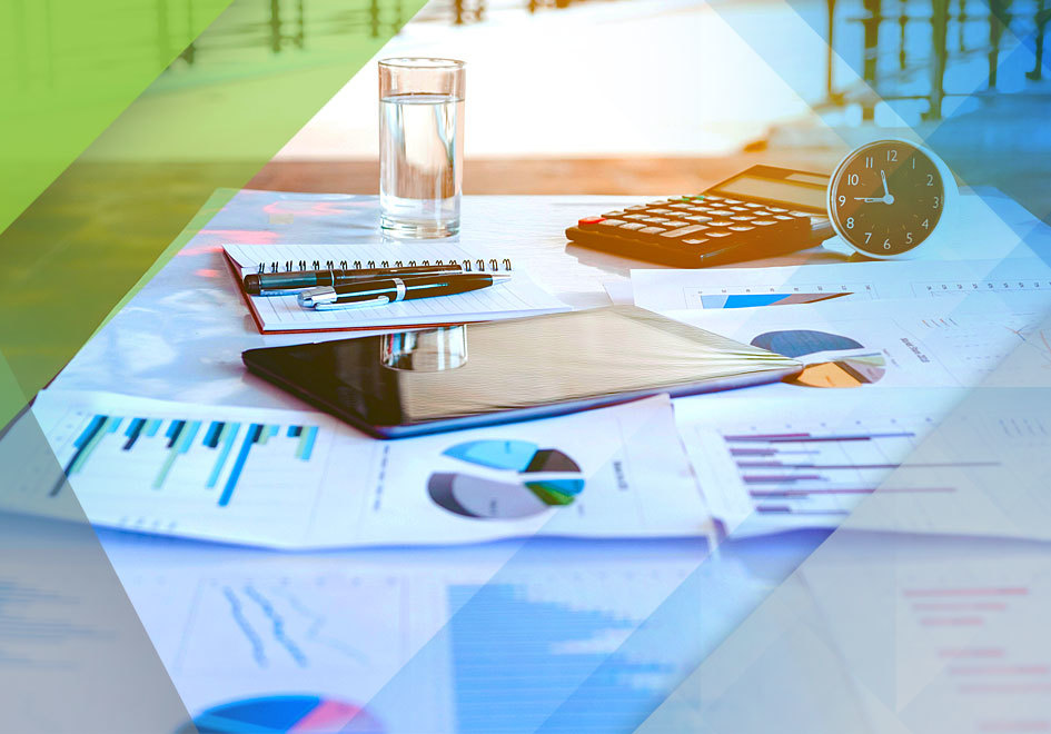 a table with documents, calculator, and graphs