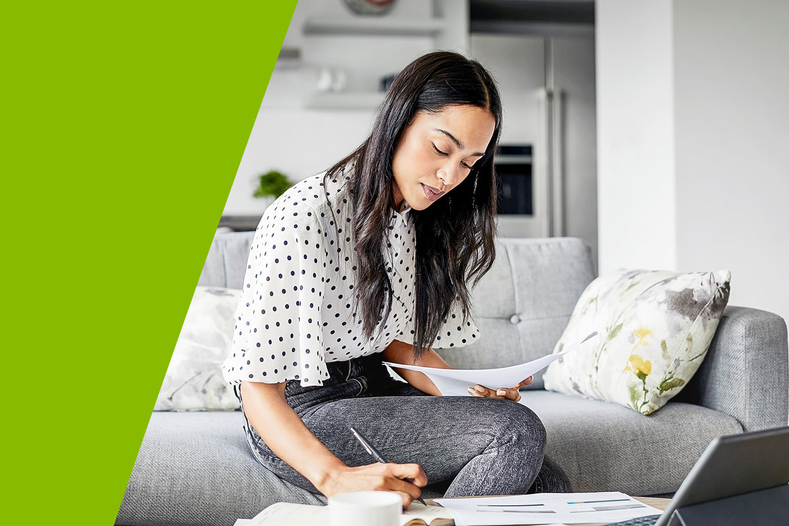 woman on a couch examining documents