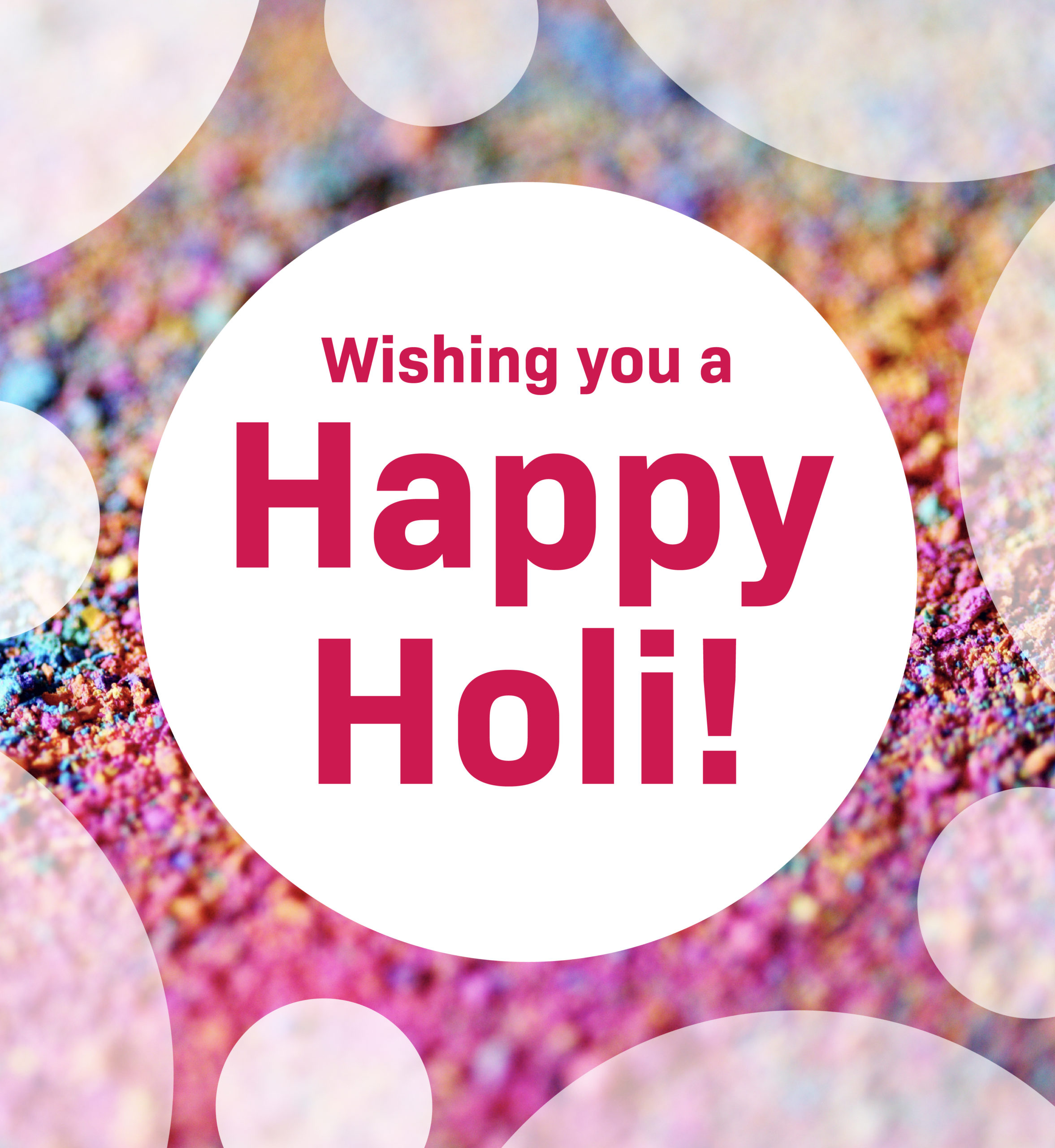 Close up of Holi color powder. Text: Wishing you a Happy Holi.