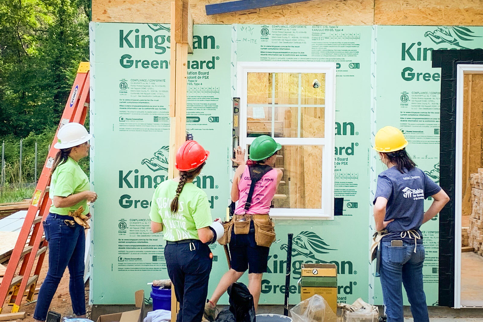 women assisting with home-building