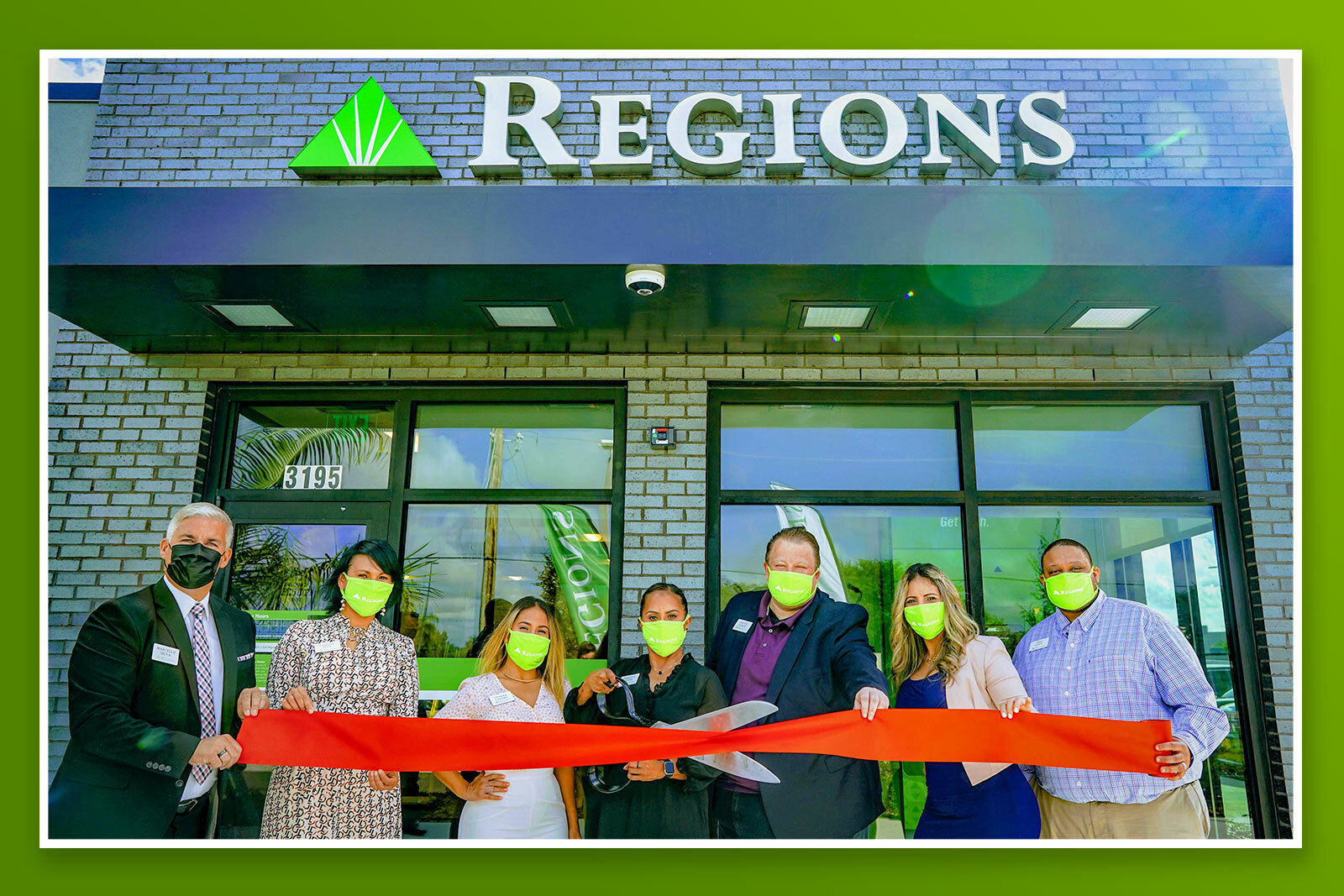 Associates cutting the ribbon in front of new regions branch