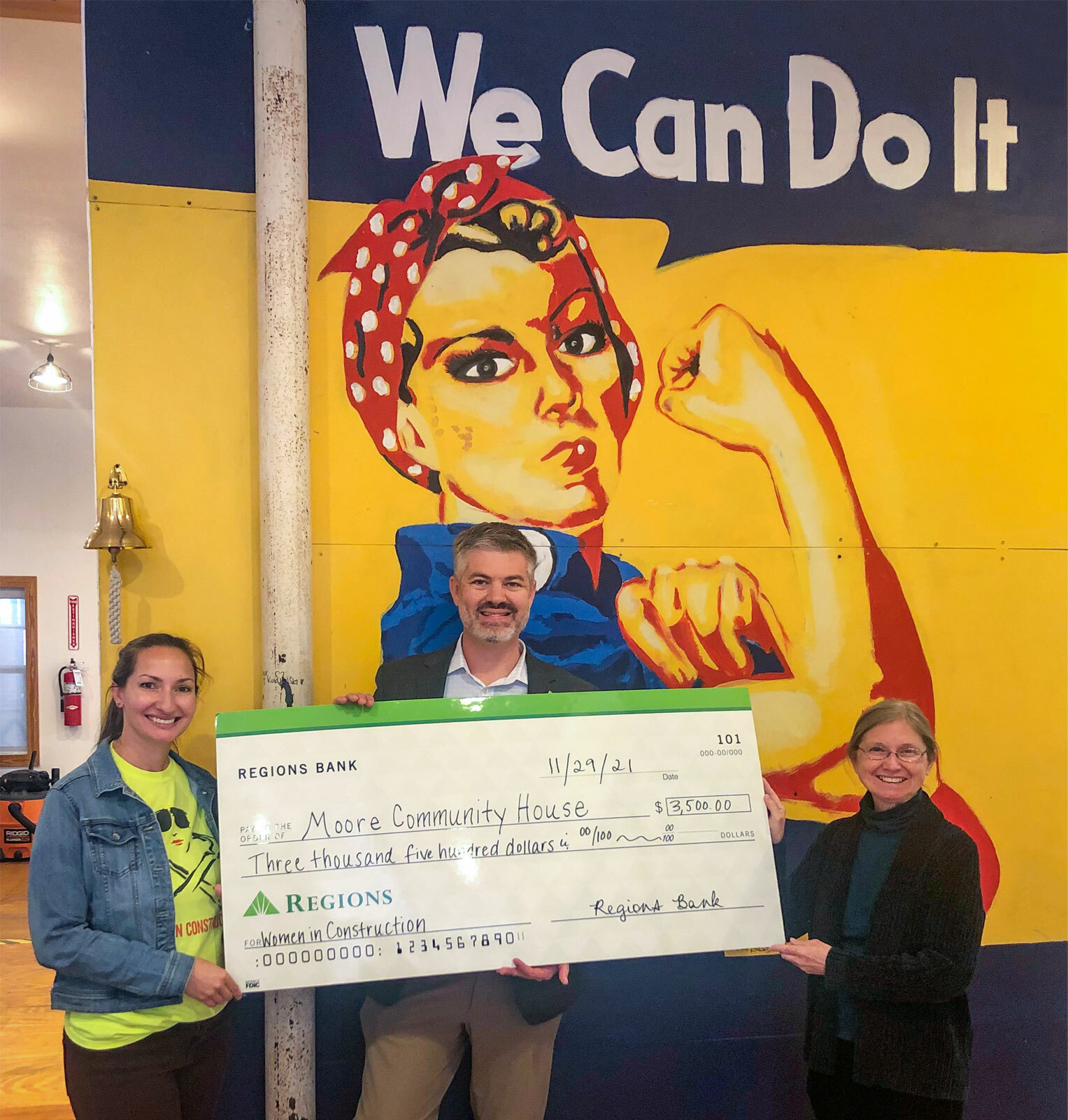 in front of Rosie the Riveter mural