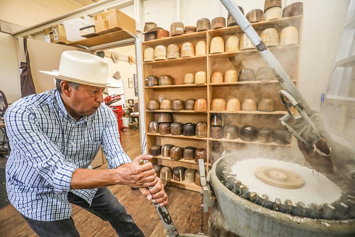 Nate Funmaker shapes a hat. The attention to detail is why his offerings fetch a pretty price.