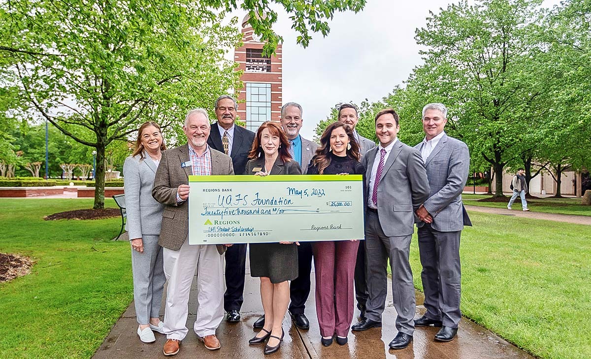 people presenting a check