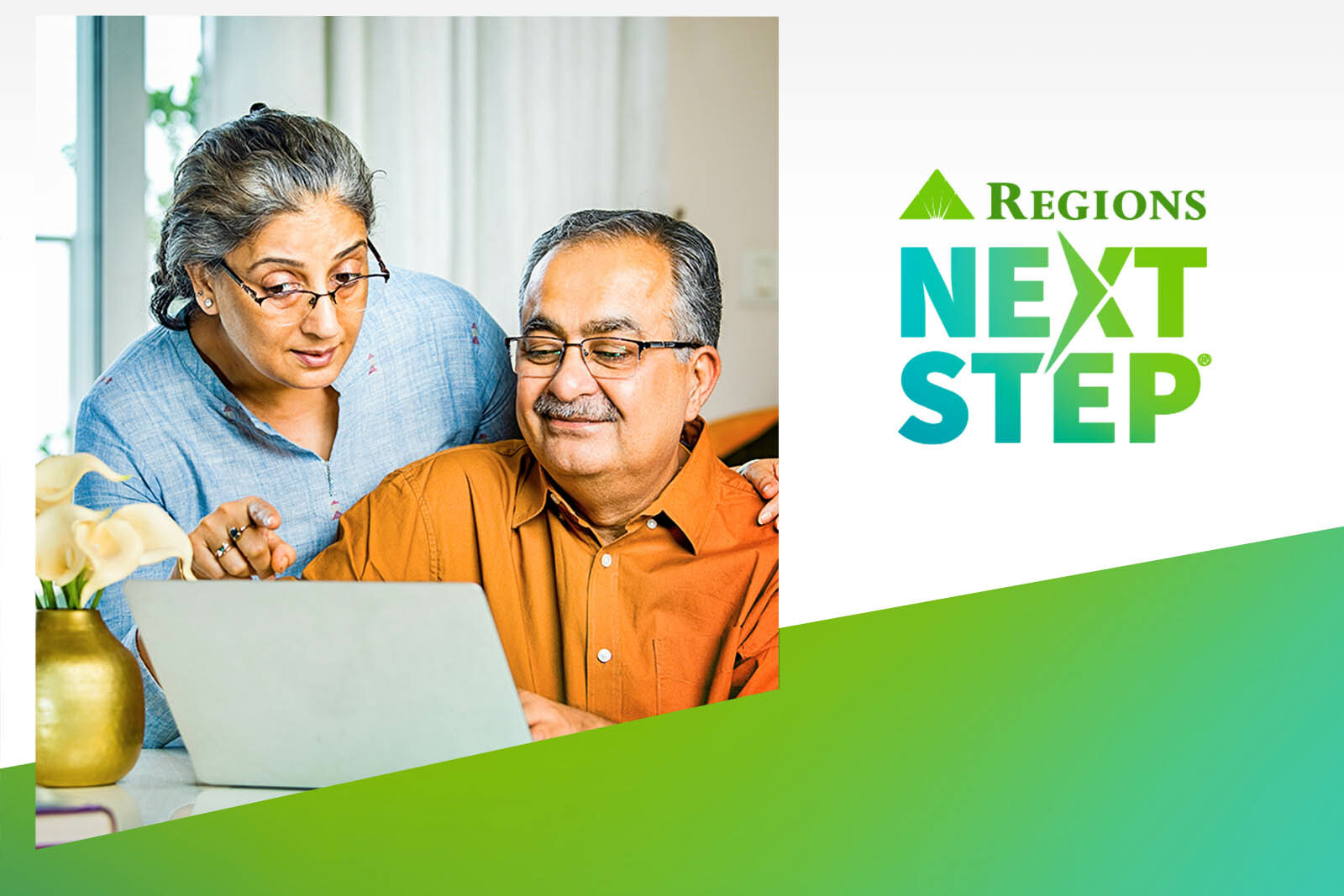 Senior couple looking at a laptop and smiling