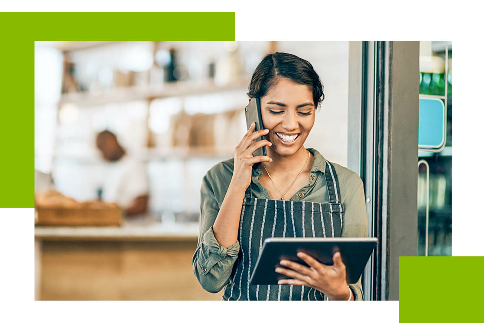 photo of barista looking at an ipad while talking on...