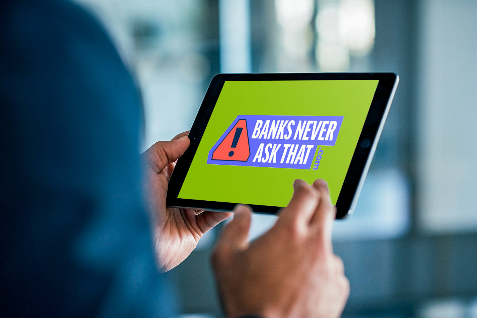 close up of person holding tablet, with banks never ask...