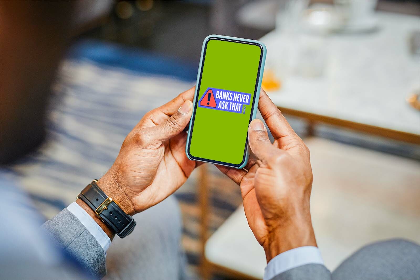 closeup of an older person's hands holding a mobile phone....