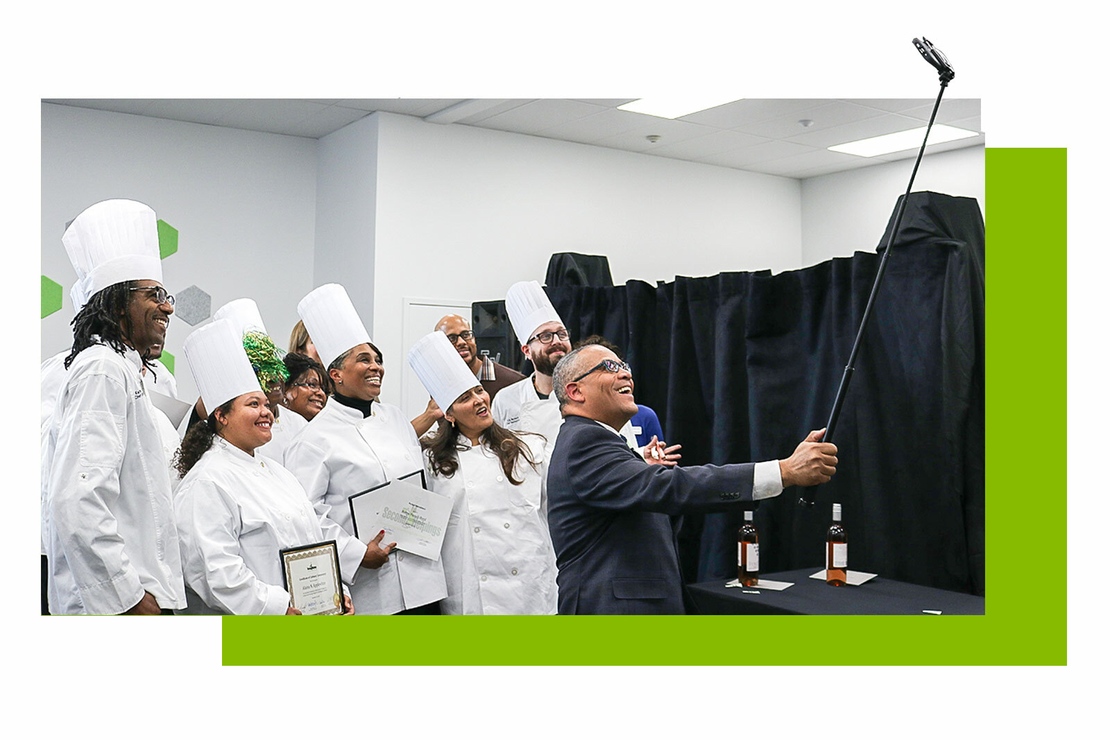 Photo of Raphael and Grads taking a selfie with a selfie stick.