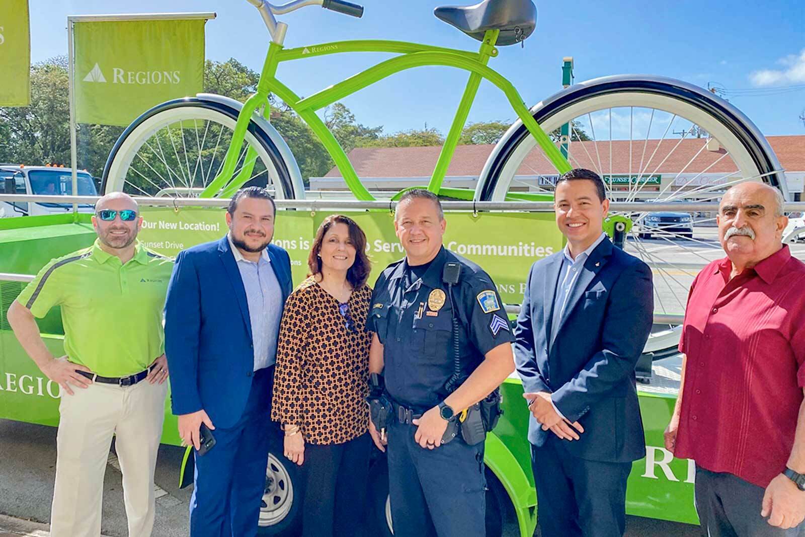 Sunset Place Appreciation event with associates and police officer in front of big bike