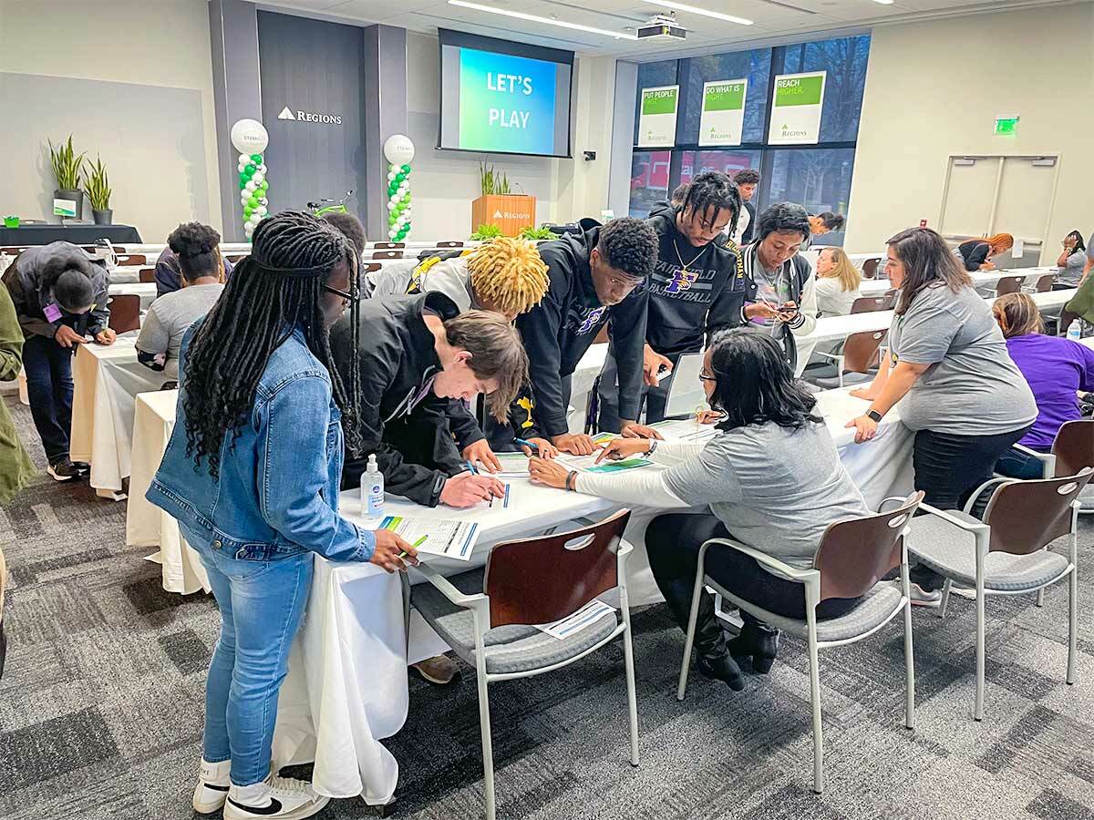 photo of students crowded around a table to write