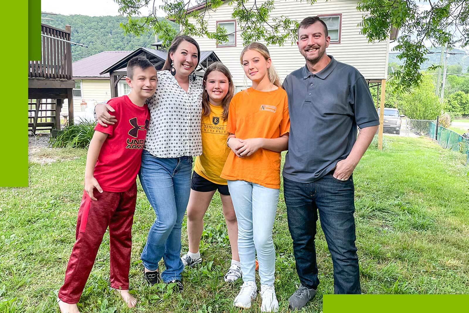 Family picture - parents with three kids in front of...