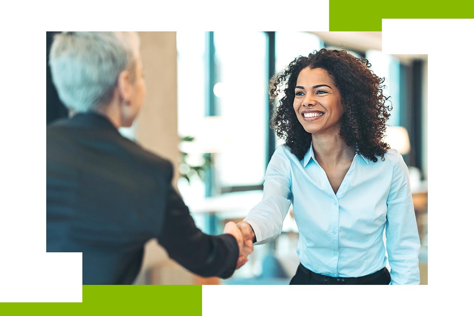 two women shaking hands