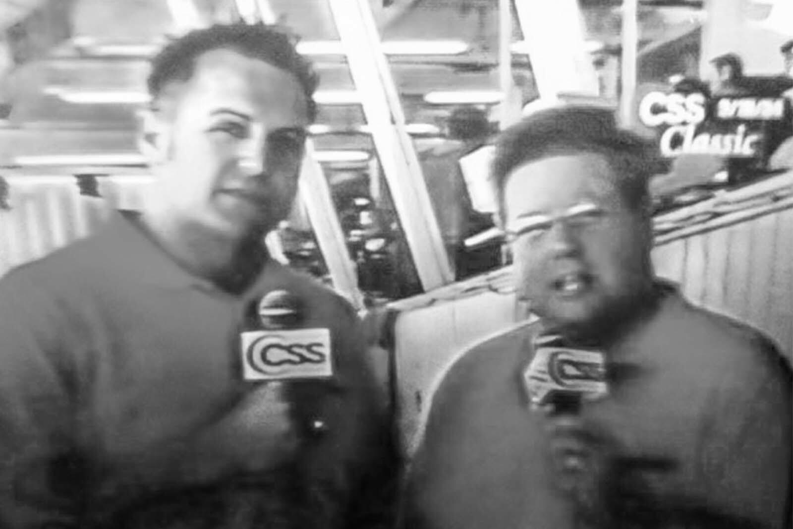 Two people talking on microphones 