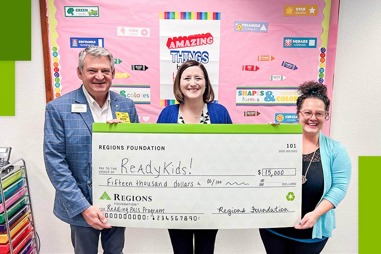 Three people holding a check from Regions Foundation