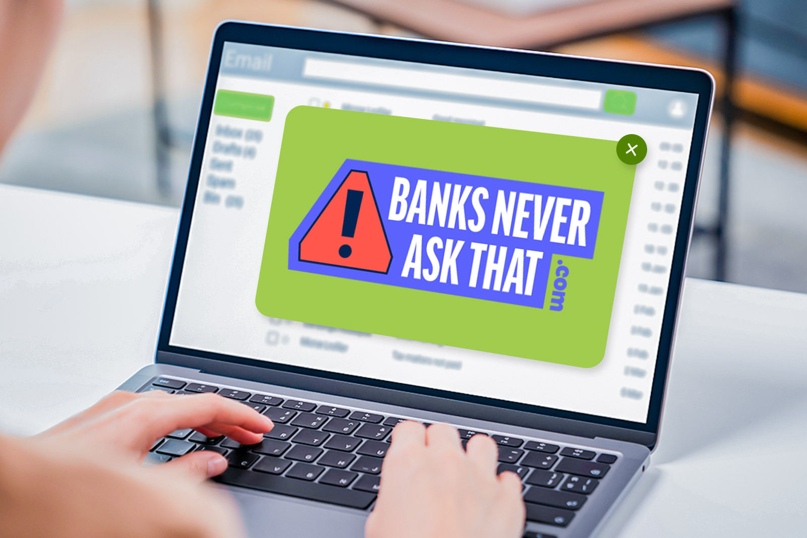 laptop with email inbox on screen with a large popup...