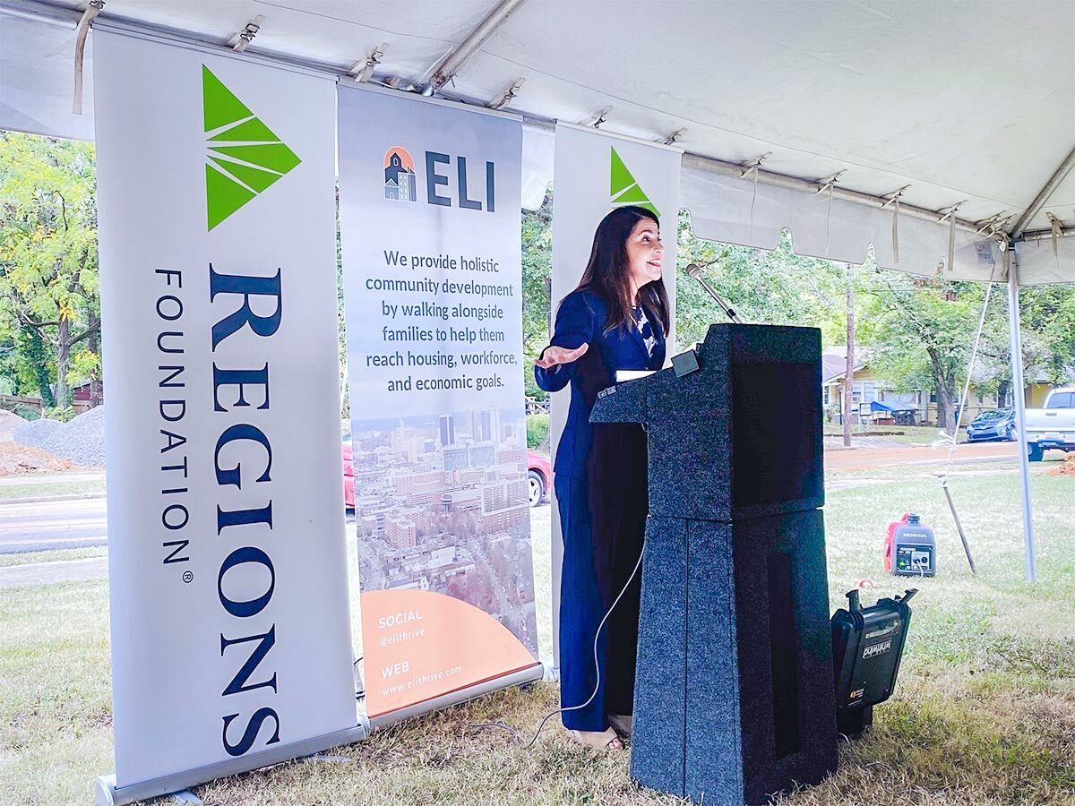 Marta Self speaking at podium