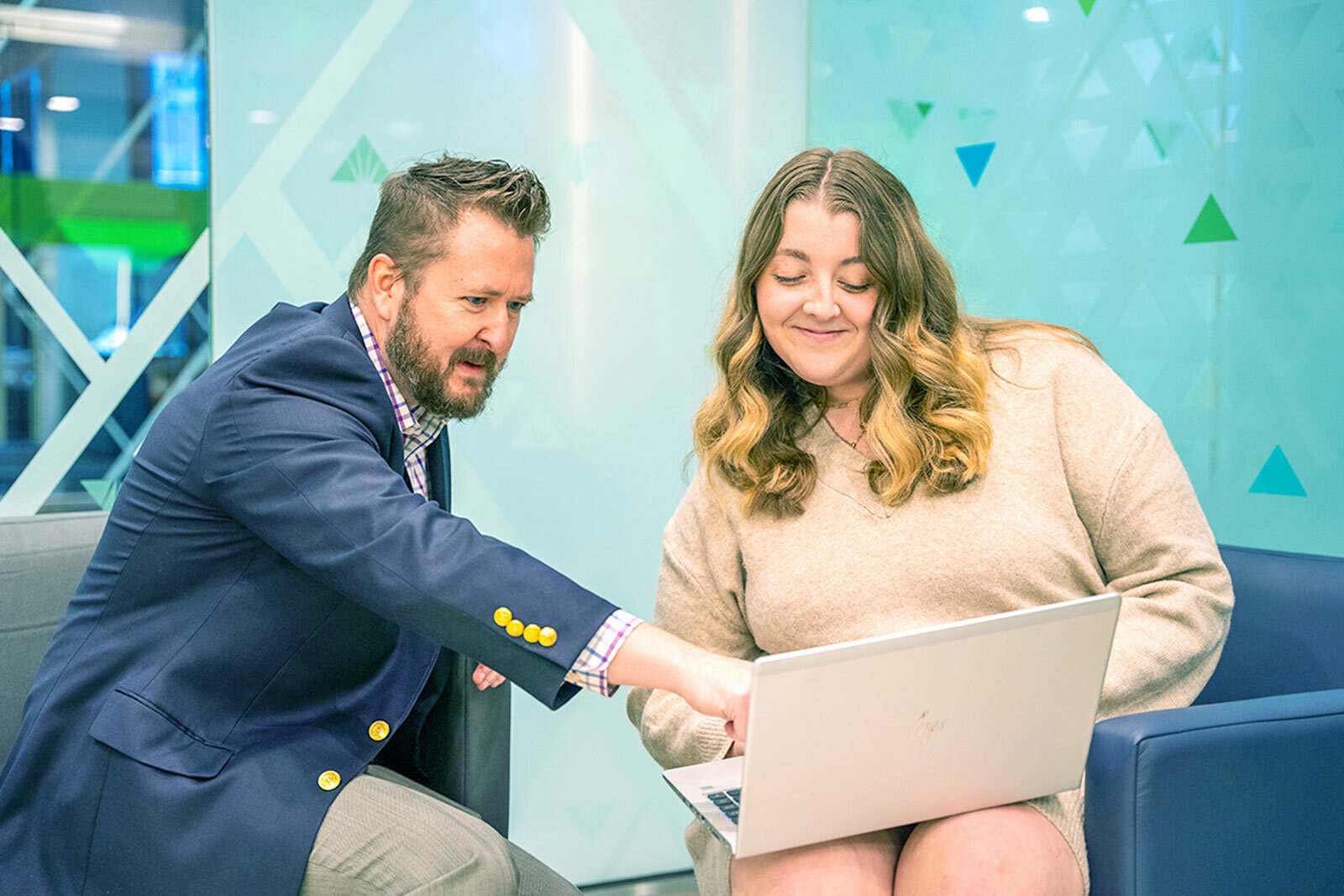 Joshua Campbell and a woman looking at a laptop together.
