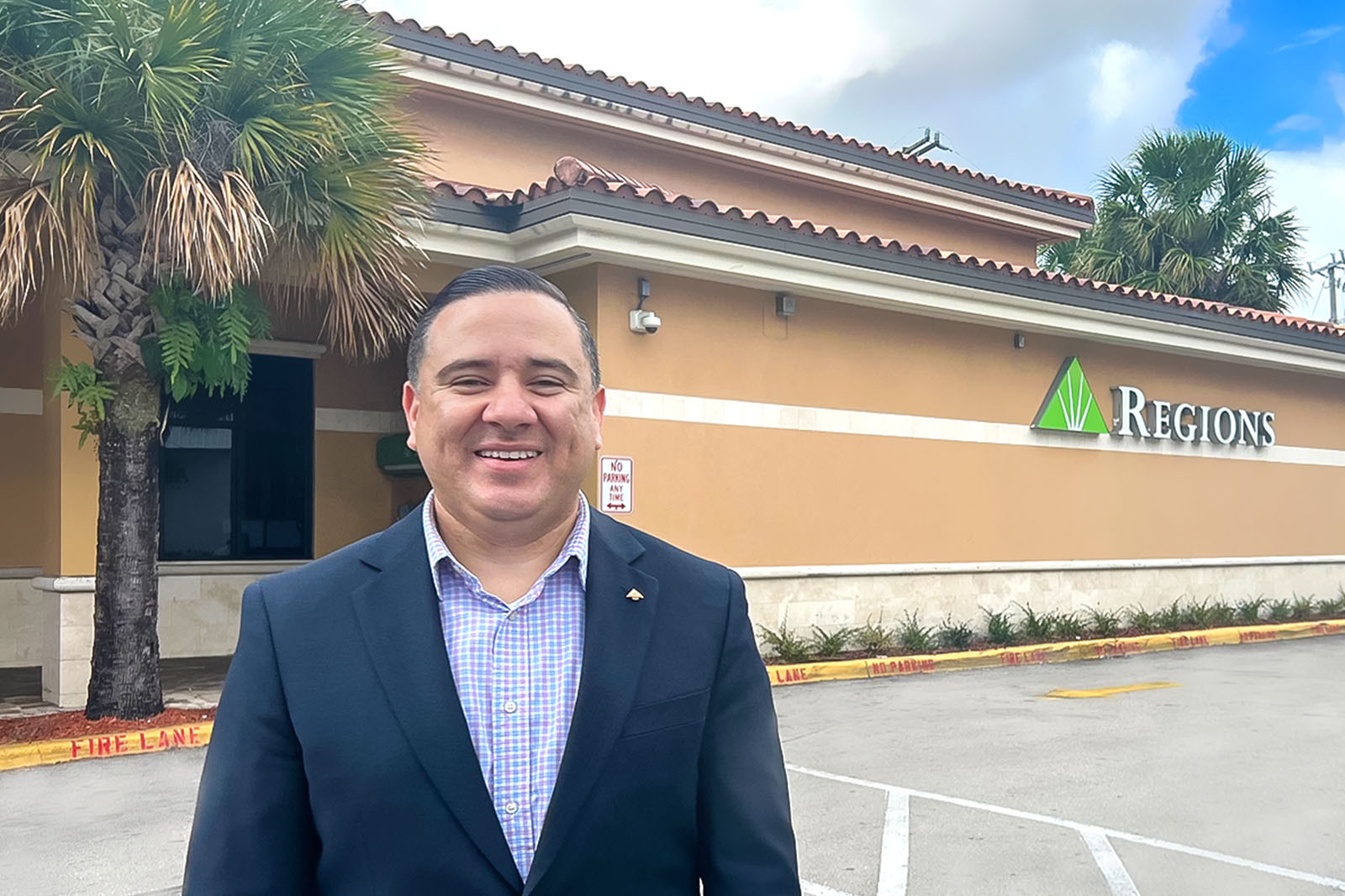 Carlos Zepeda in front of Regions Bank branch