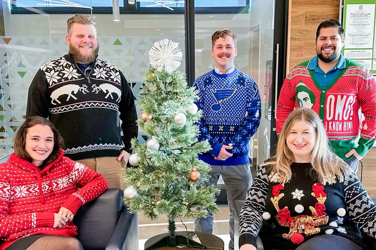 A group of associates in Christmas sweaters