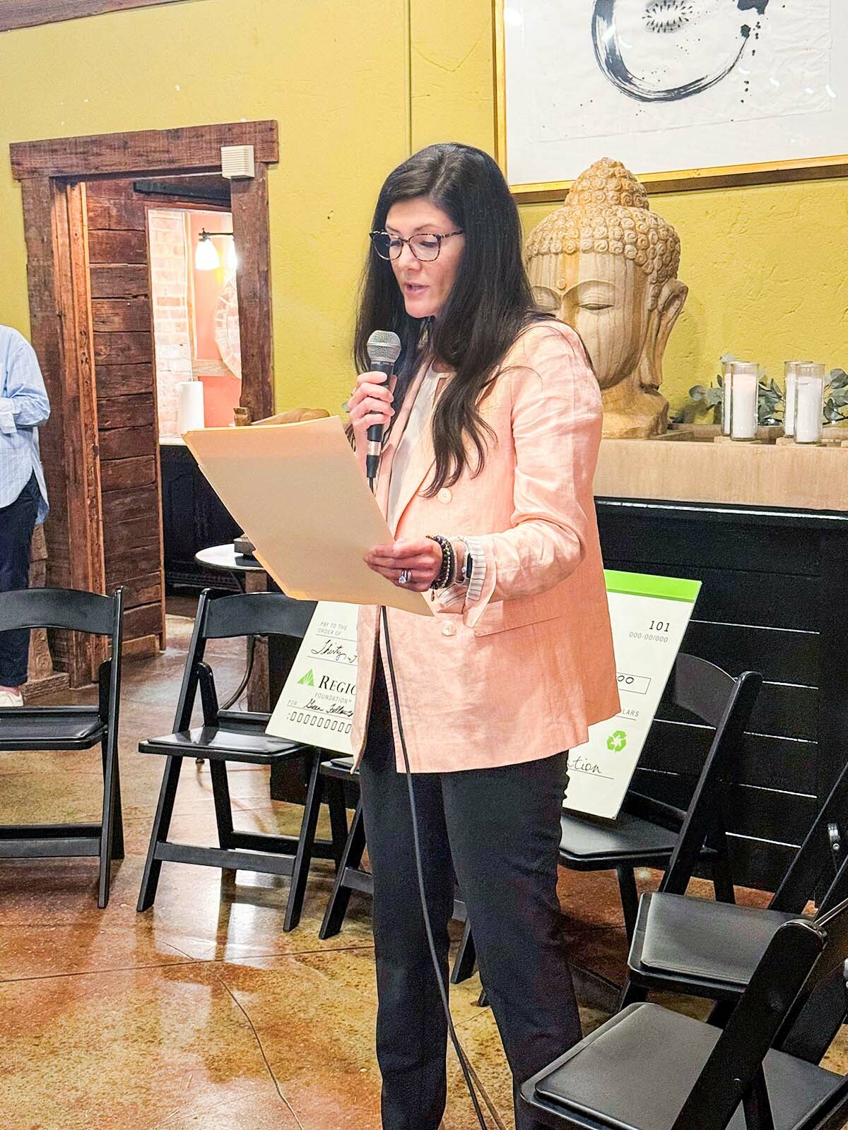 Woman talking at the Teach For America check presentation event