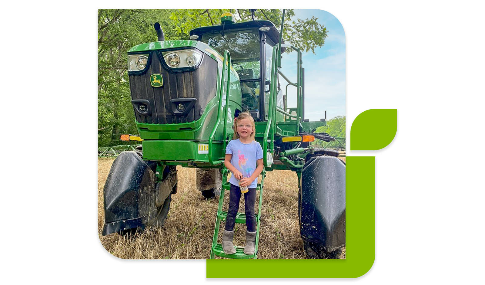 Photo of a young girl in front of a tractor.
