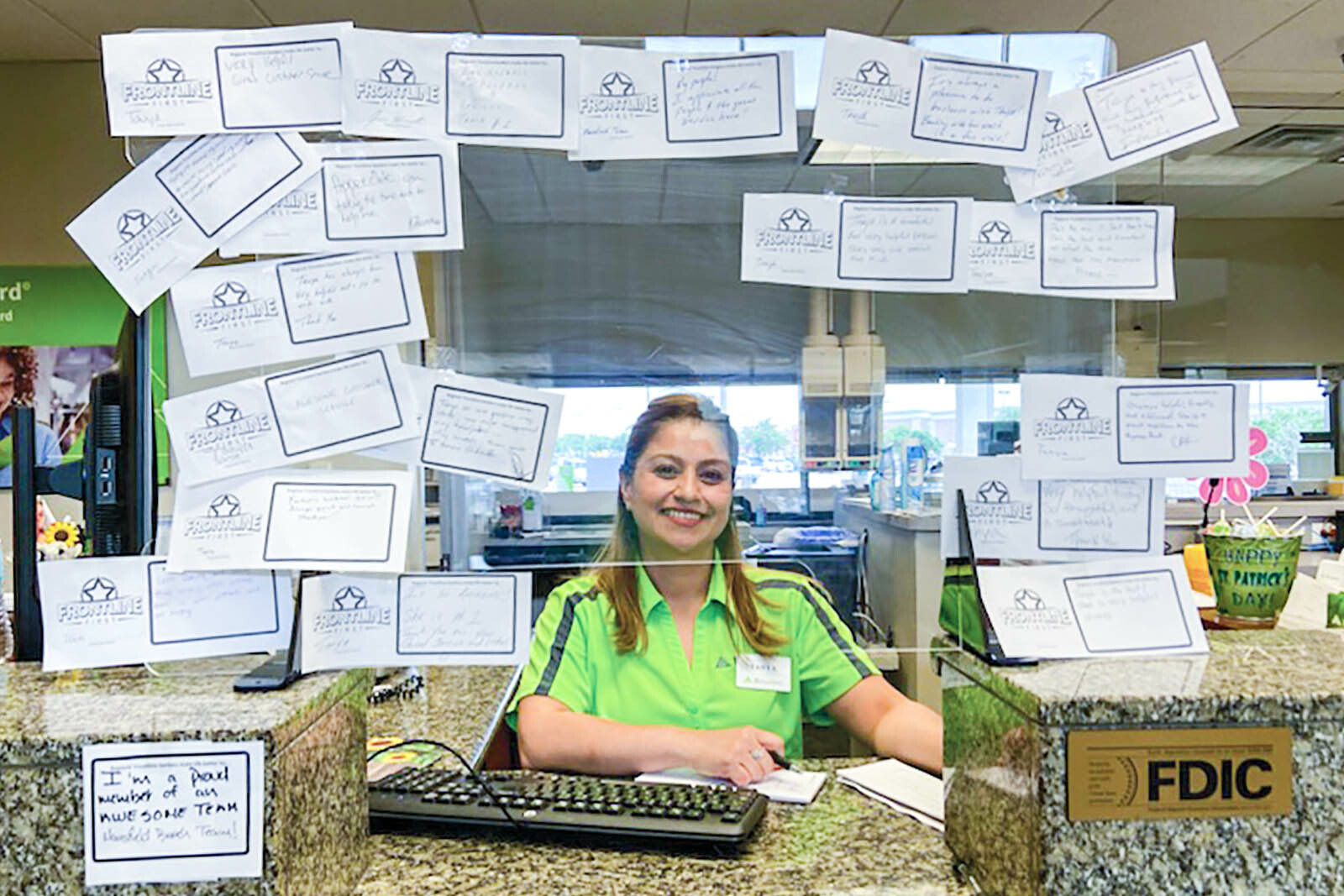 Photo of Regions associate behind desk with sticky notes with...