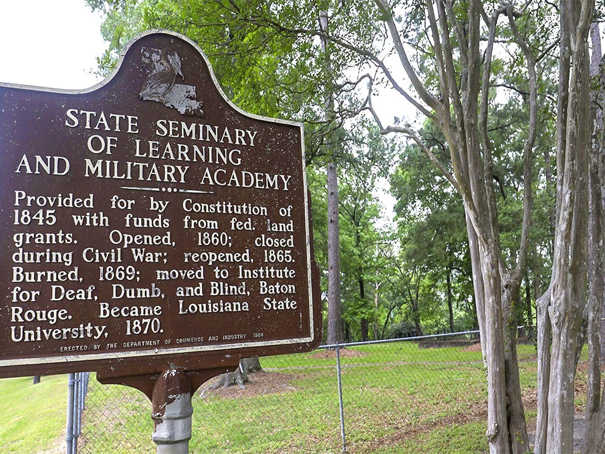 A historical marker next to a national forest denotes the location of the original Louisiana State University campus outside Alexandria, which opened in 1860.