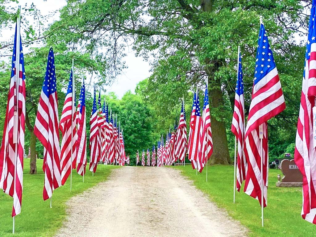 a path flanked by American flags