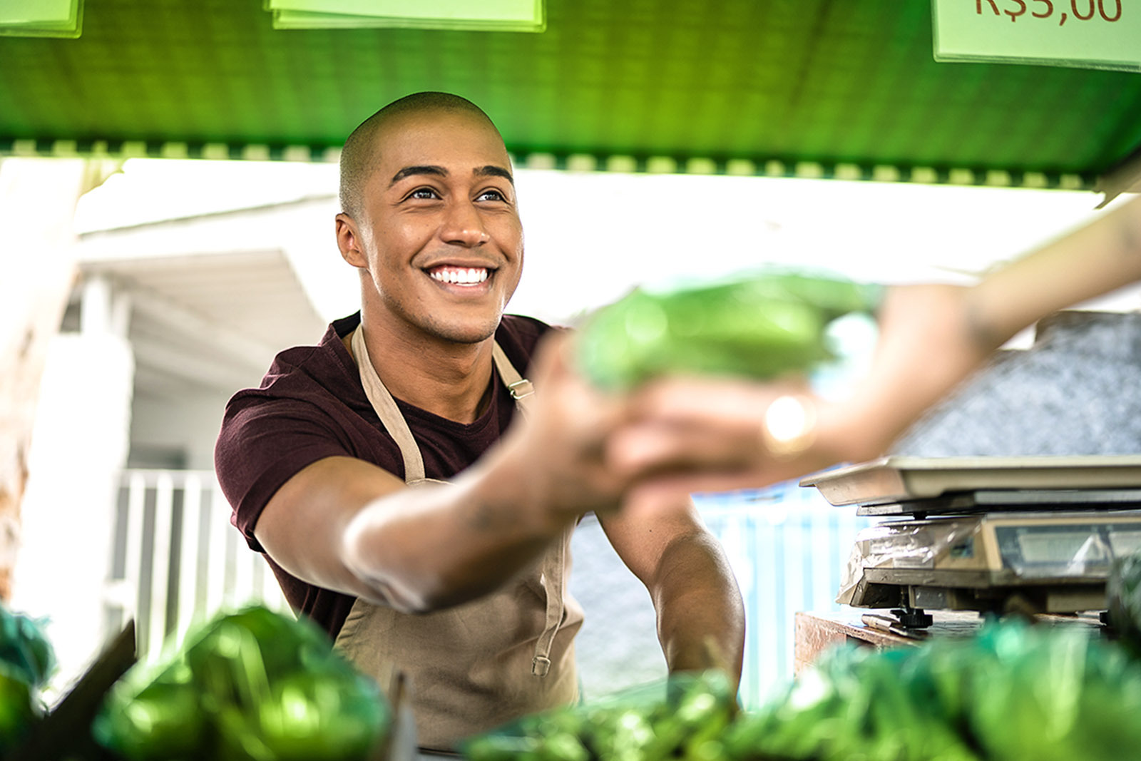 Hispanic person selling fresh products at the market