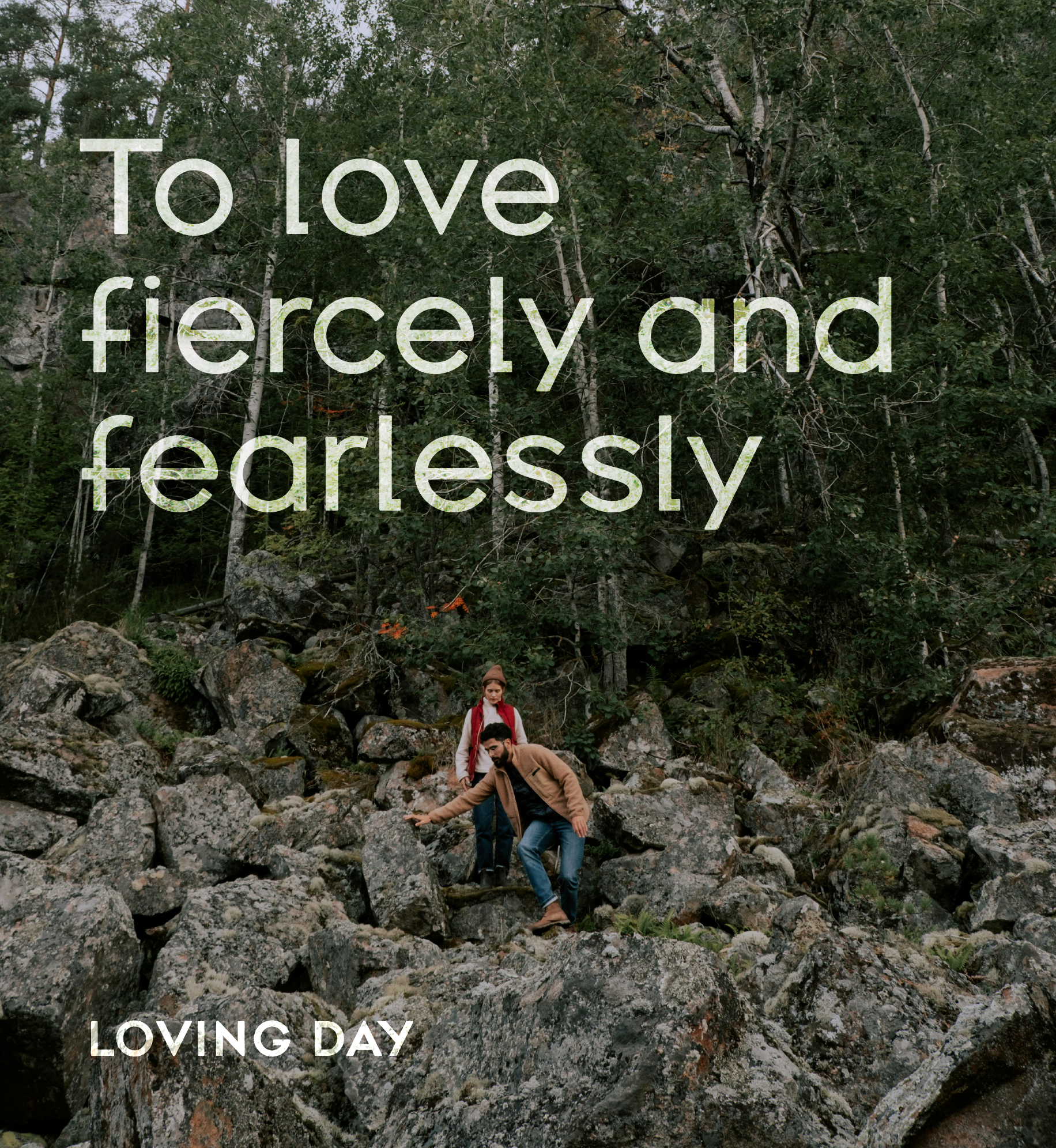 Couple hiking on rocky terrain. Text: To love fiercely and fearlessly. Loving Day.