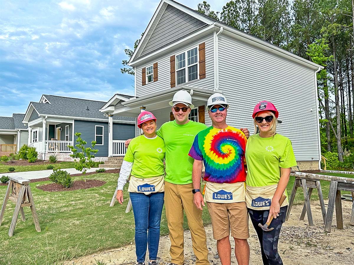 volunteers for Habitat for Humanity in front of house