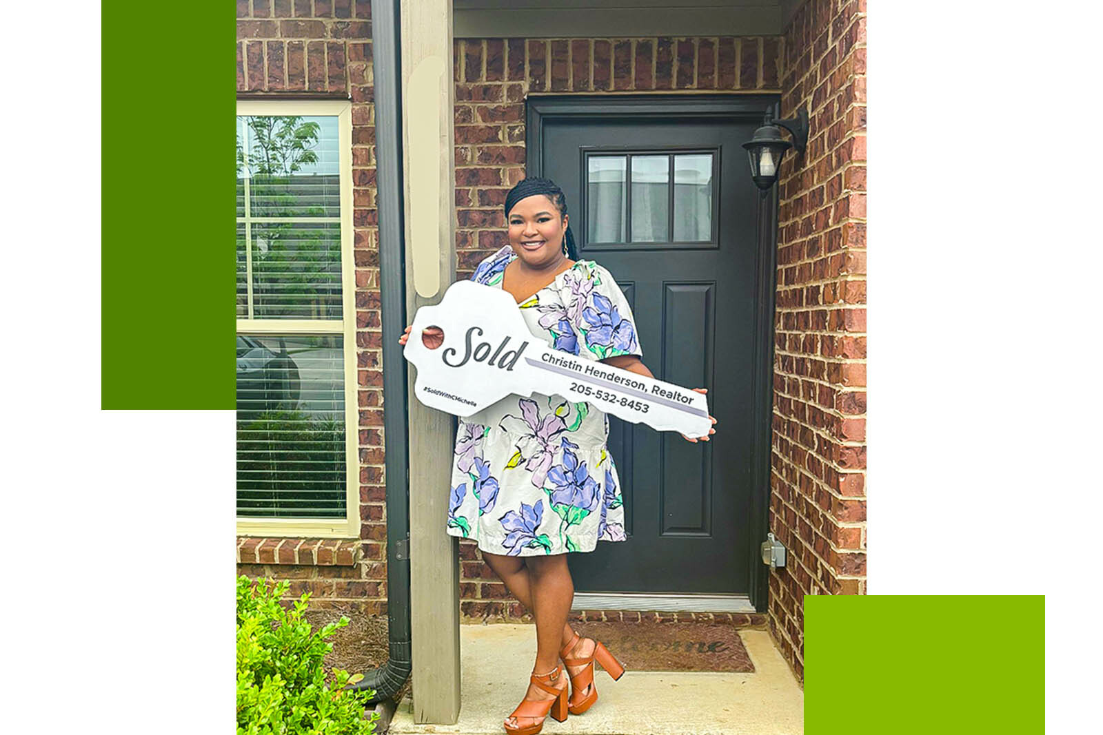 female homeowner holding a large key in front of her...