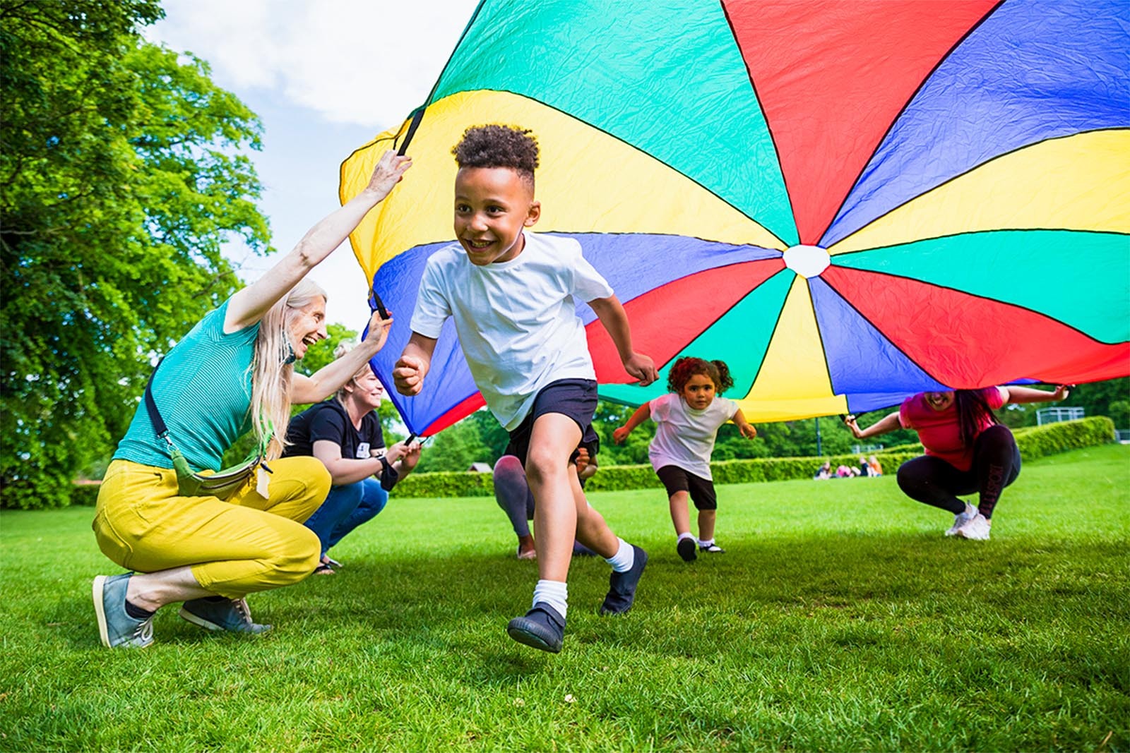 School children playing with a parachute