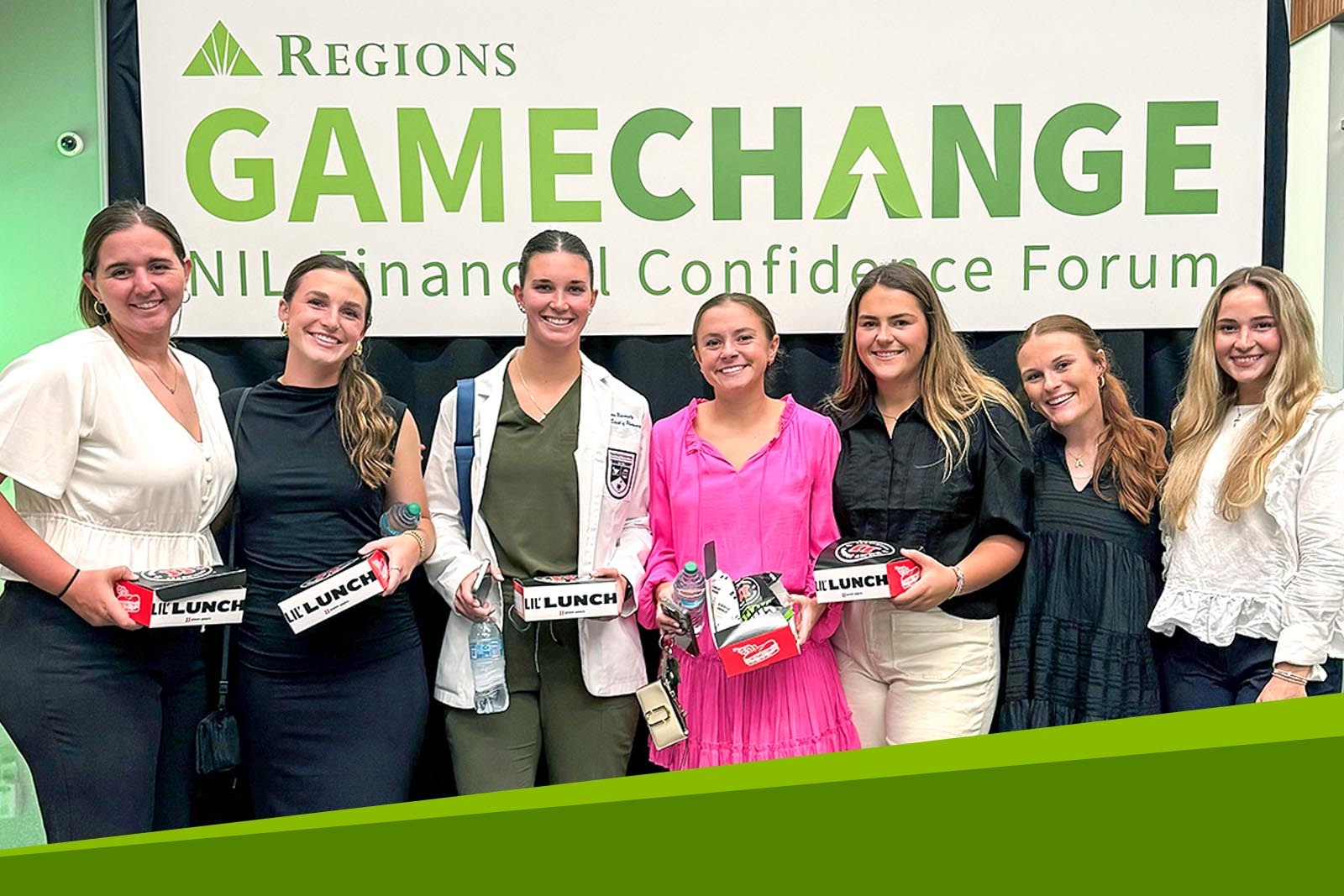 Group of attendees standing in front of Regions Game Change...