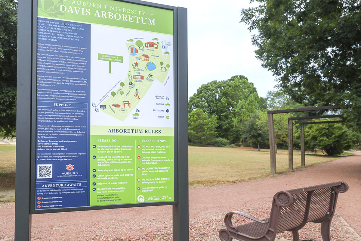 A map greets visitors at the Donald E. Davis Arboretum, showing directions to the 2 miles of accessible walking trails and the 13.5 acres of trees, native plants, ponds and waterfalls.