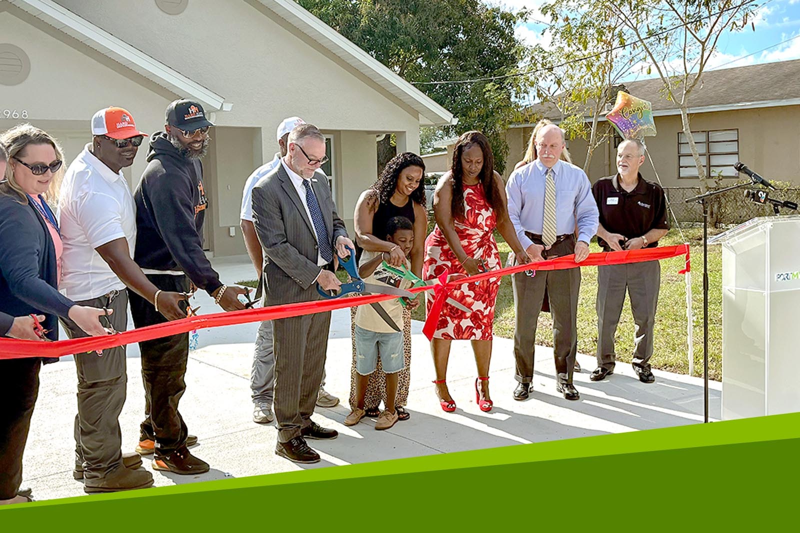 Ribbon-cutting ceremony in front of the Latisha Jewett's new home...