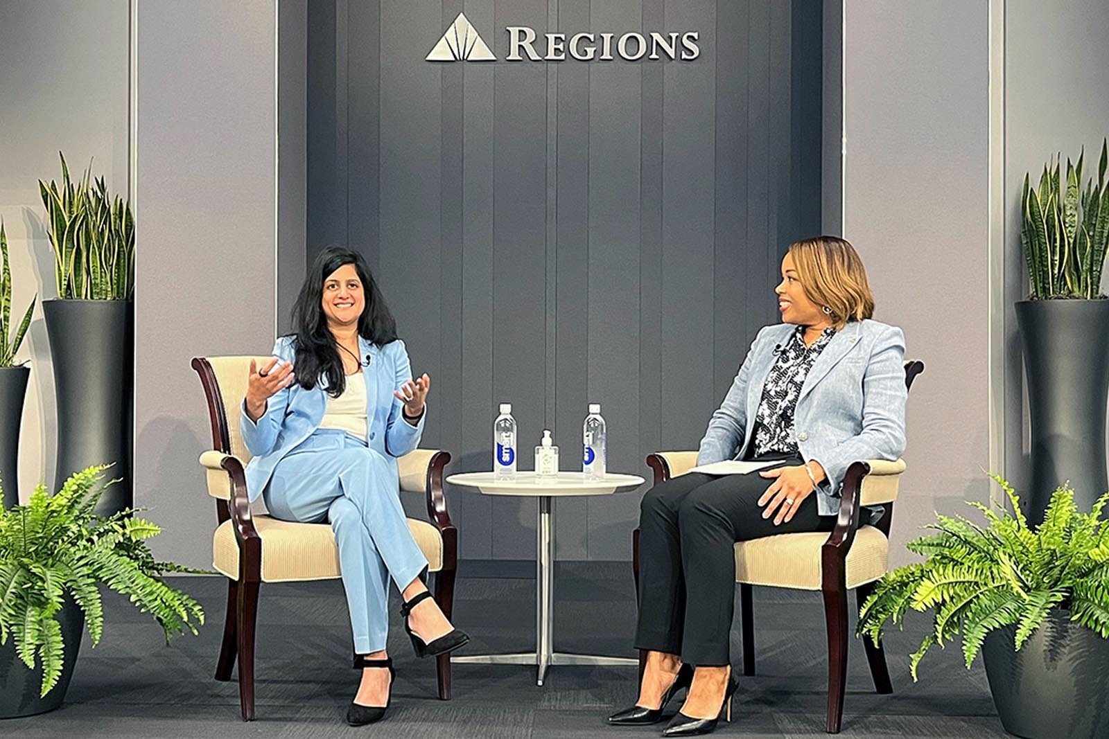 Bijal Shah and Seanna McGough sitting on stage speaking to...