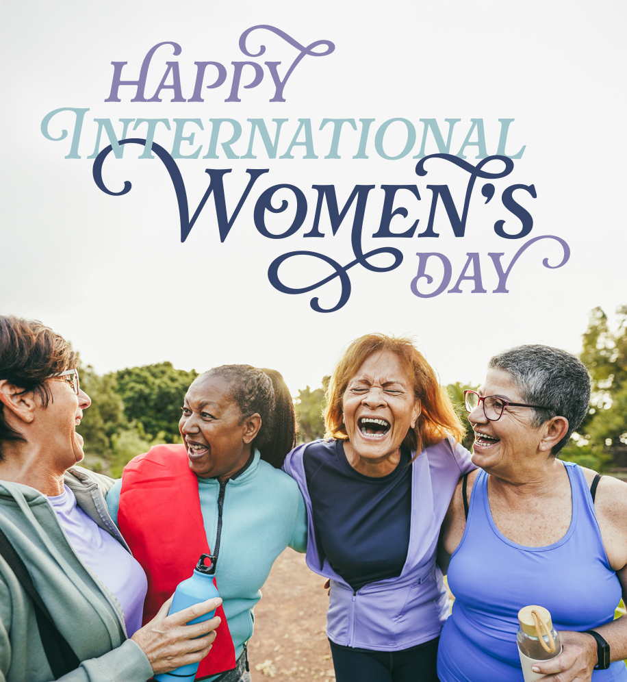 Group of women with their arms around each other laughing. Text: Happy International Women's Day.
