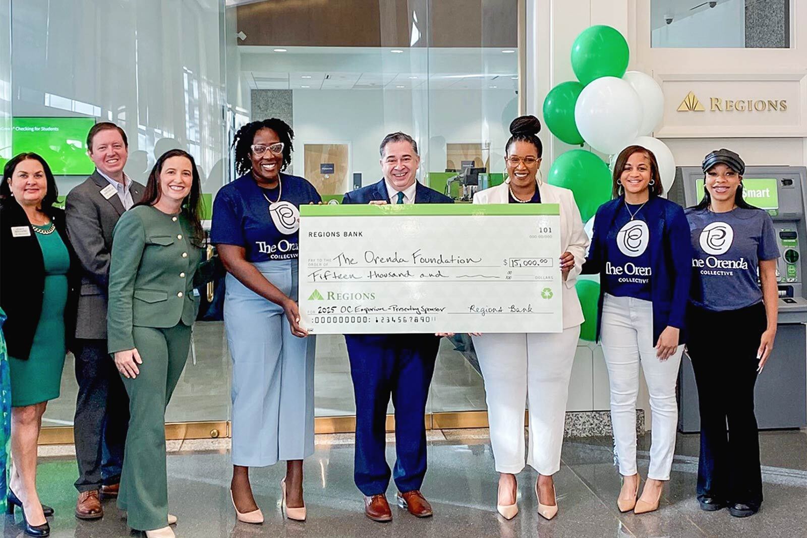Regions associates presenting check to The Orenda Foundation at the opening of the renovated downtown Tampa branch.