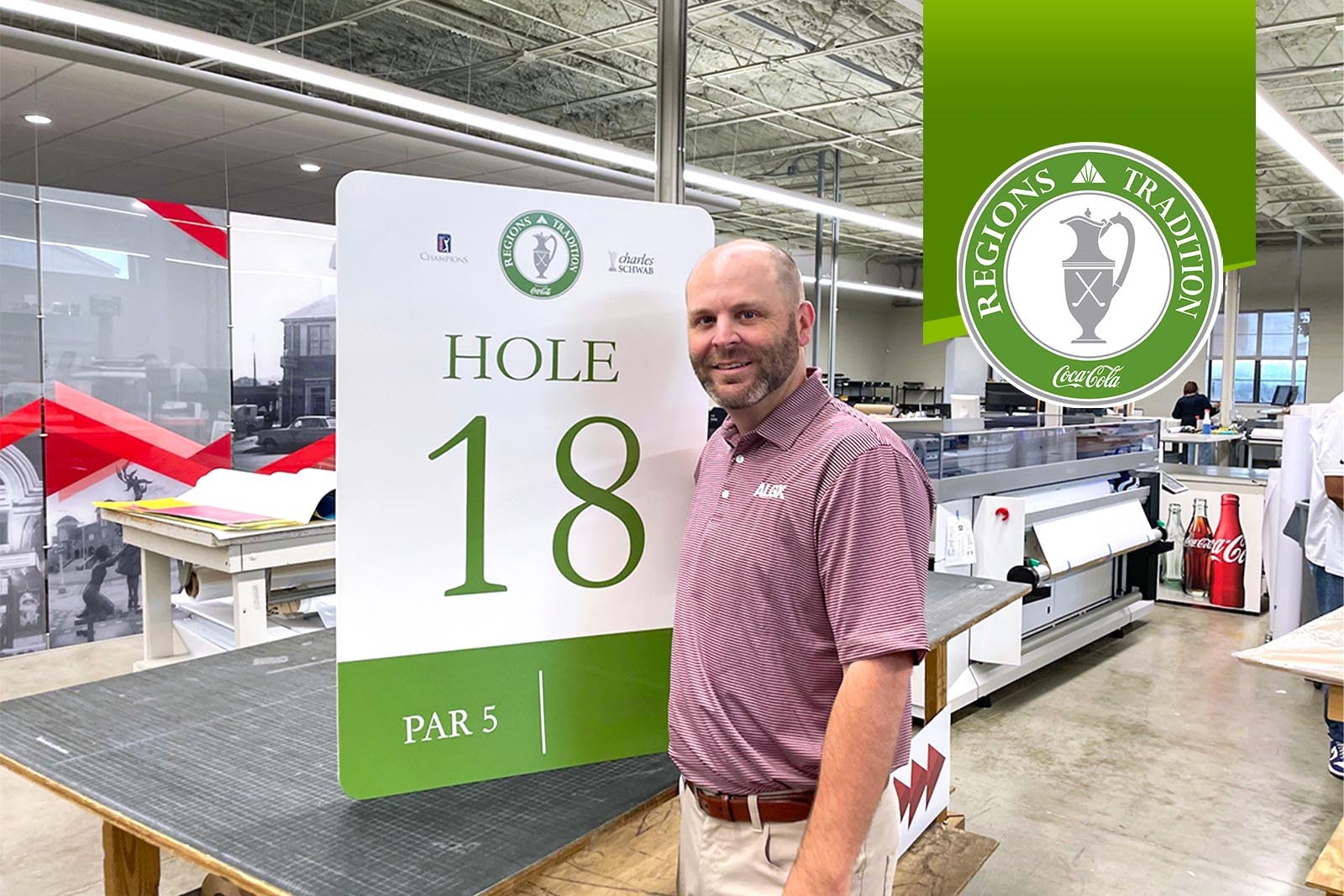 John Davis, owner of Alabama Graphics standing next to a...