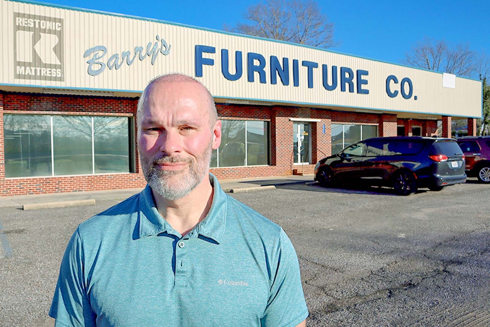 Chuck Odom in front of the Barry's Furniture storefront. 