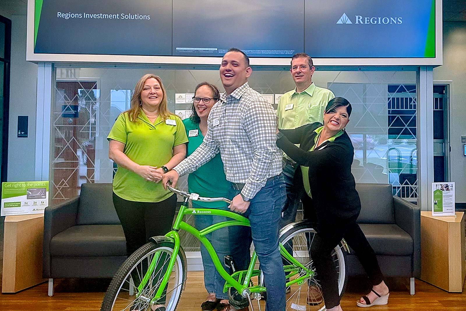 Renzo Bravo, manager of the Regions branch in Spring, Texas and his team celebrating Frontline First week.
