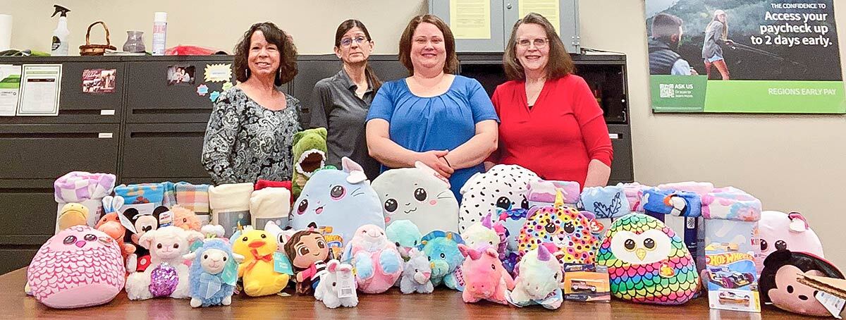 Group of associates from Delphi, Indiana with the donated blankets and stuffed animals for local police departments in Carroll County.