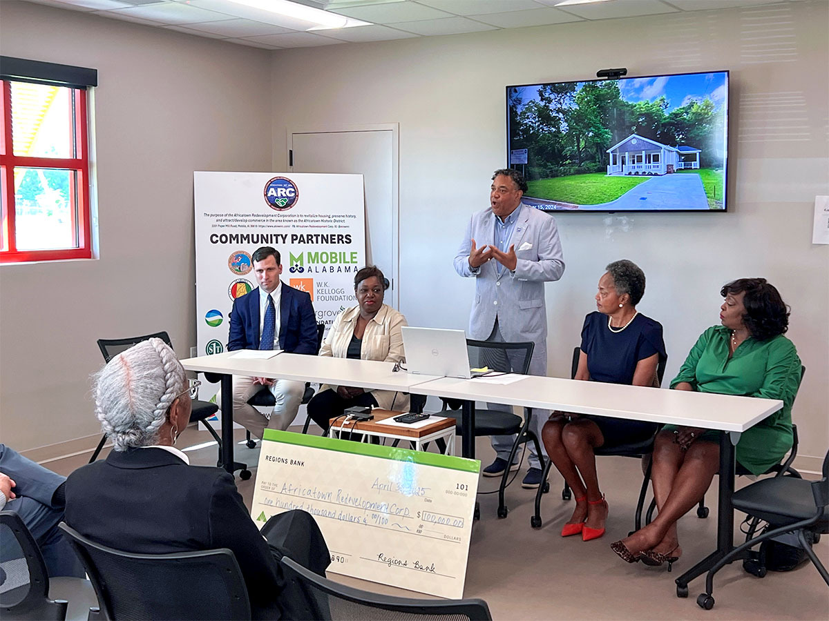 Regions associates and Africatown Redevelopment Corporation (ARC) members speaking to group.