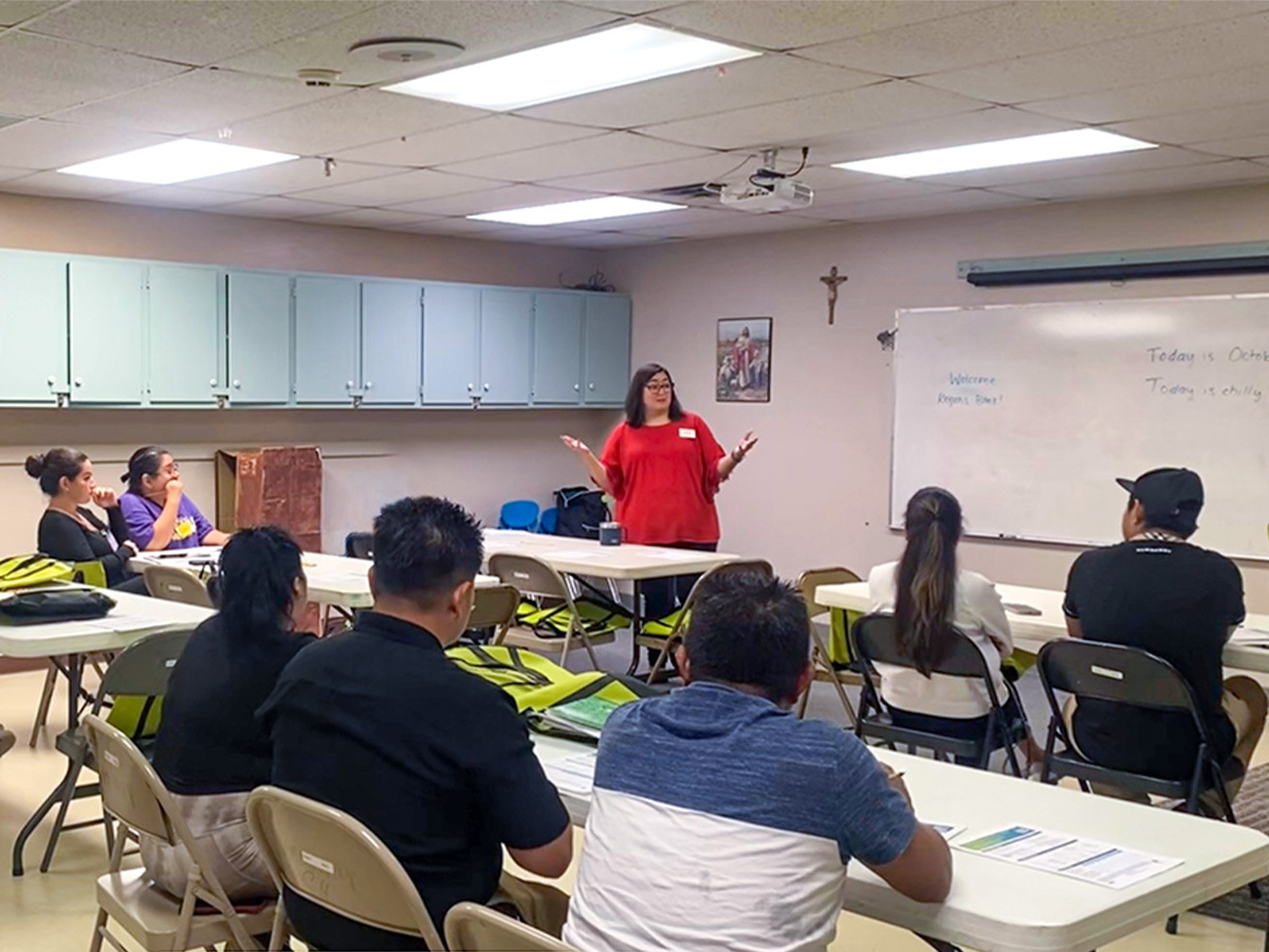 Keren Treme, Regions Community Engagement Financial Education Trainer speaking in front of ESL class.