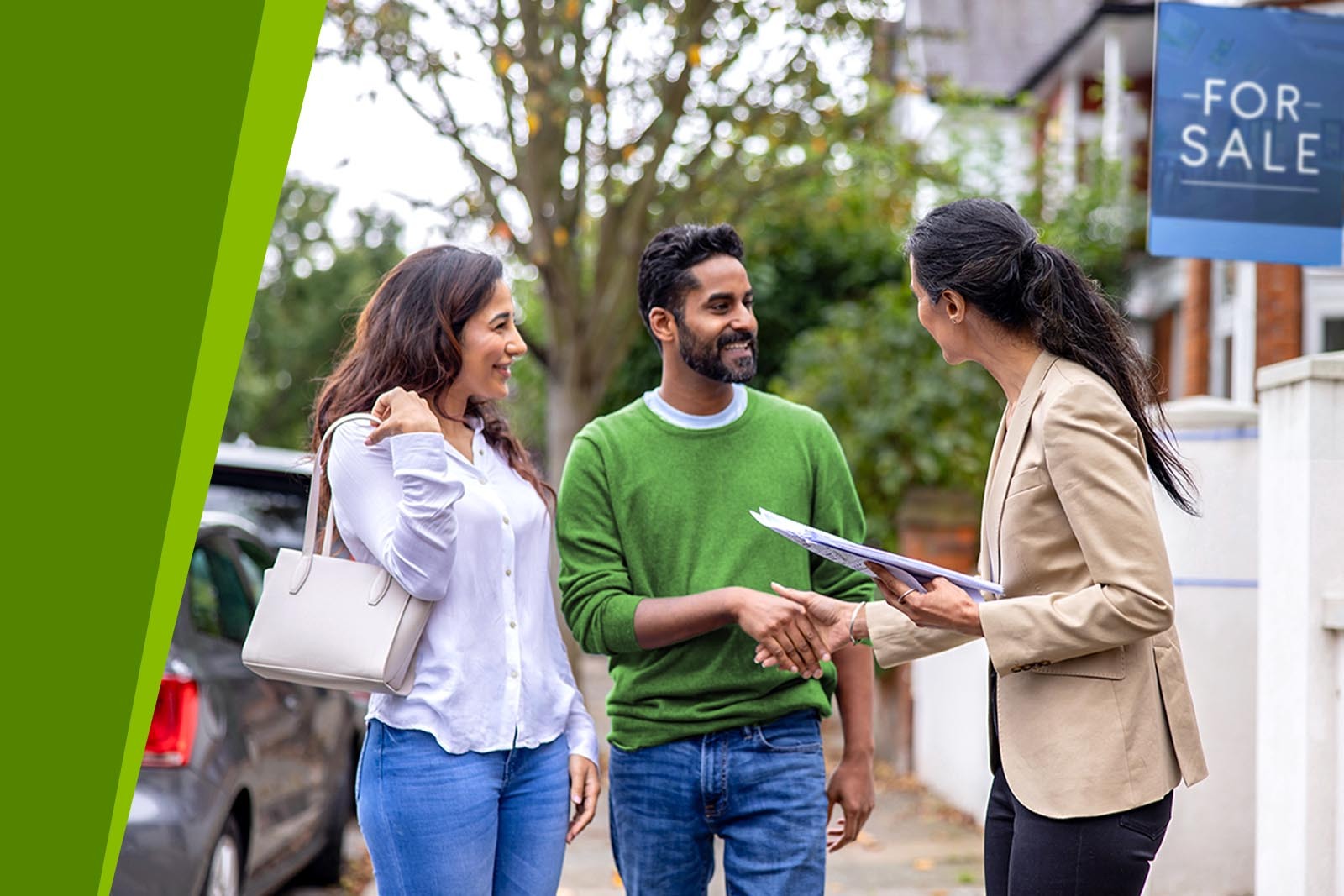 Realtor shaking hands with homebuyer.