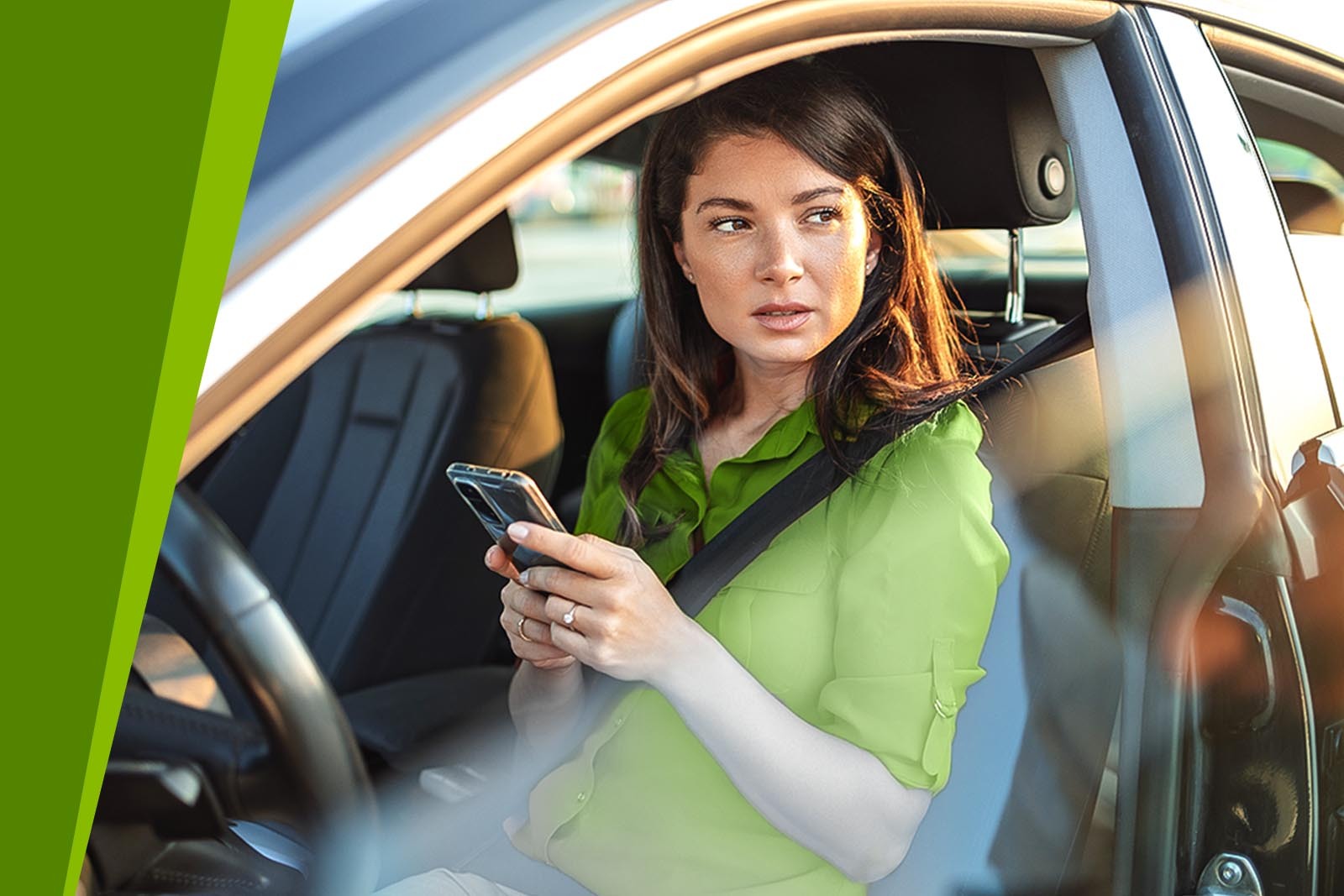 A young woman texting on her smartphone while sitting in...