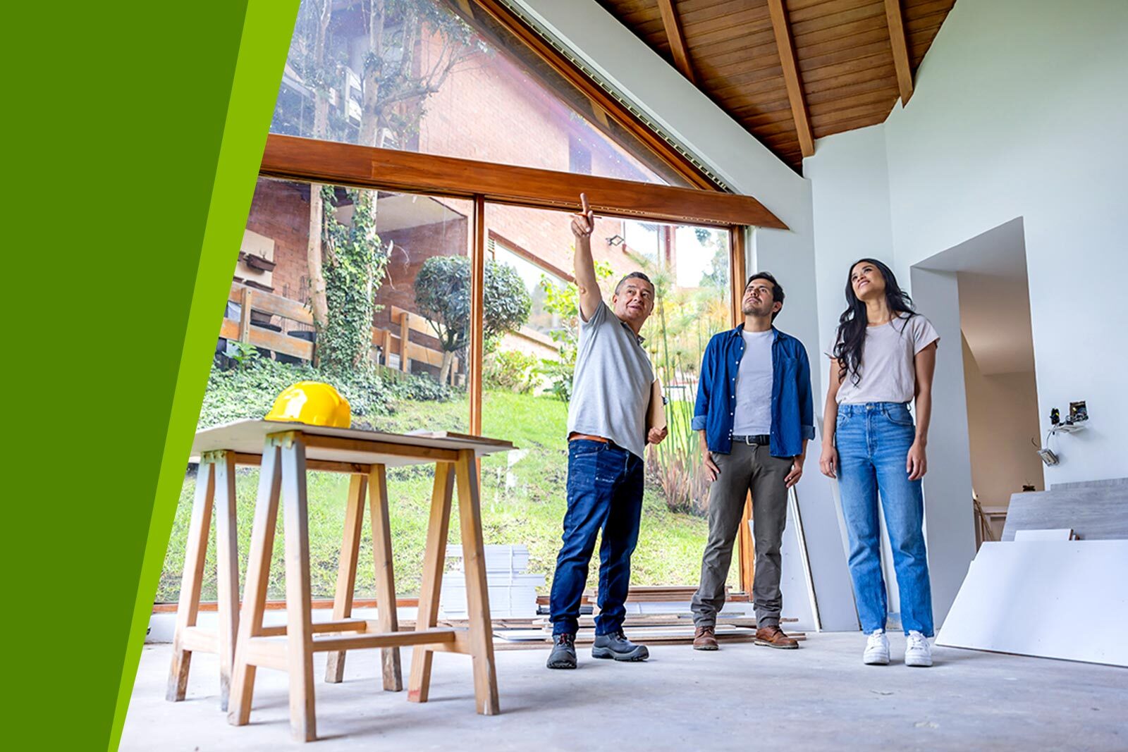 Home improvement. Building contractor talking to clients about renovating their...