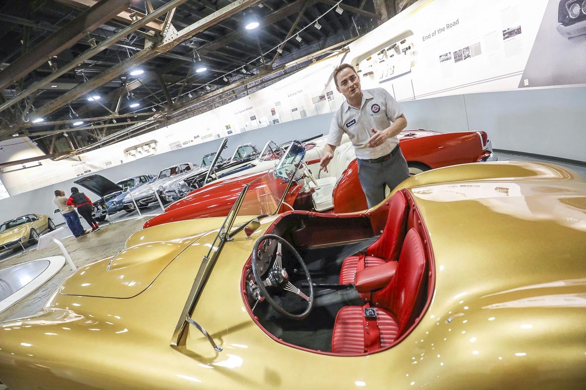 A shily gold 1951 Glasspar G2 with candy red seats at the Edge Motor Museum.